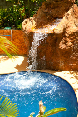 pool with waterfall feature at Roatan Backpackers' Hostel